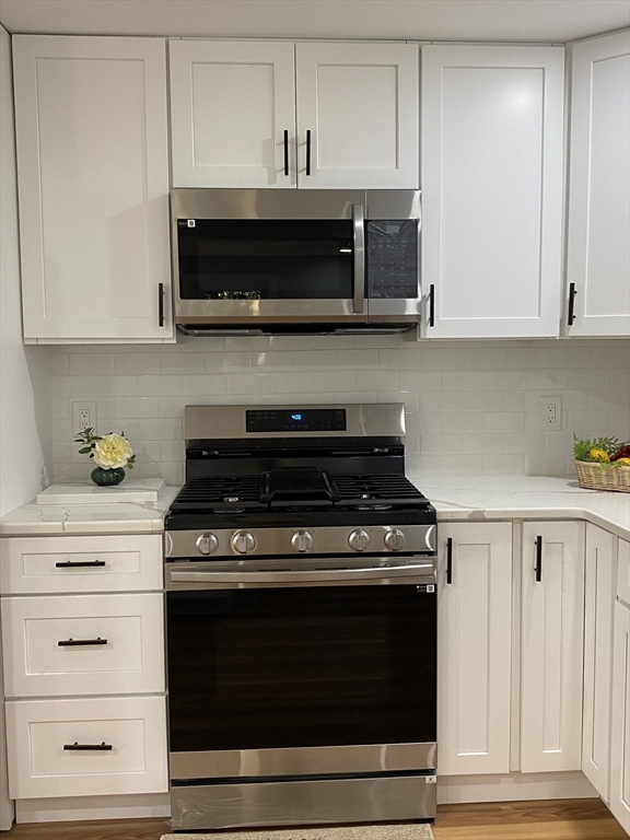 29 Styles Drive Peabody, MA 01960 - Photo 15 of 41 a kitchen with stainless steel appliances granite countertop a stove and a microwave