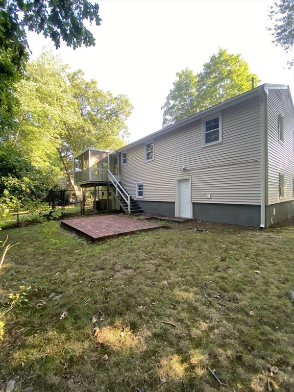 29 Styles Drive Peabody, MA 01960 - Photo 37 of 41 a view of a backyard with plants and large tree