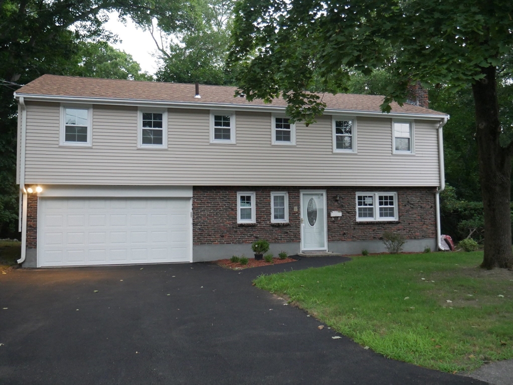 29 Styles Drive Peabody, MA 01960 - Photo 4 of 41 a front view of a house with a yard and garage