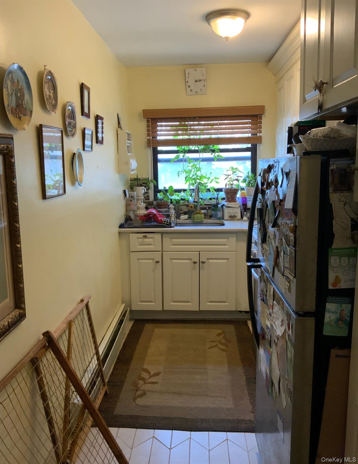 2261 Palmer Avenue, Unit 2A New Rochelle, NY 10801 - Photo 5 of 12 Kitchen featuring freestanding refrigerator, tile patterned flooring, and white cabinets