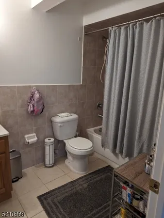 a bathroom with a toilet and a mirror