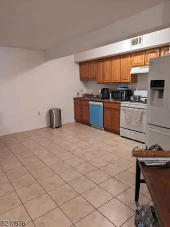 a kitchen with stainless steel appliances kitchen island granite countertop a sink cabinets and window