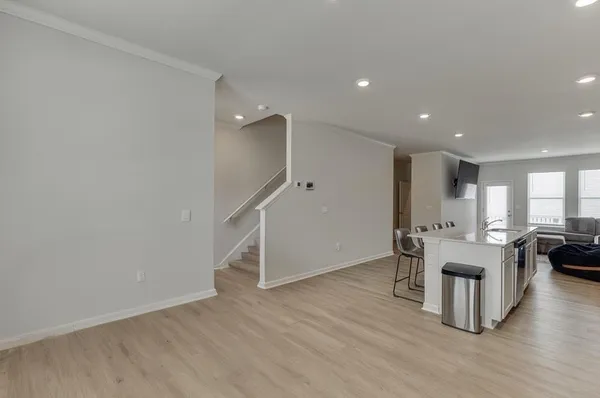 a view of a kitchen with furniture and wooden floor