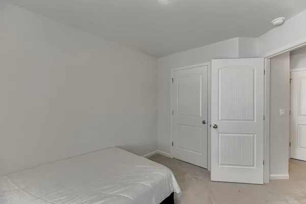 a bedroom with a bed and a shower