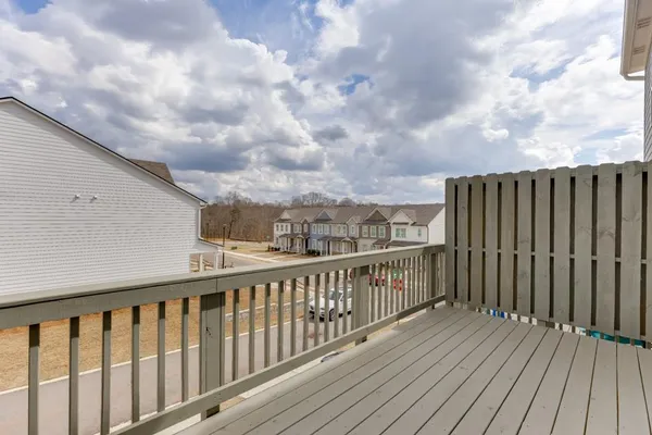 a view of balcony with wooden fence