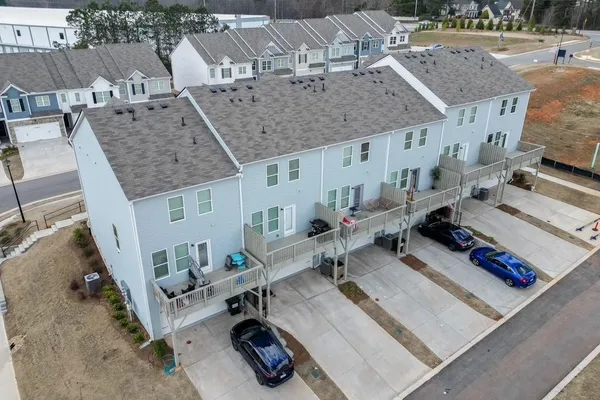 an aerial view of a house with a backyard
