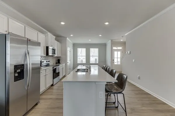 a kitchen with refrigerator cabinets and wooden floor