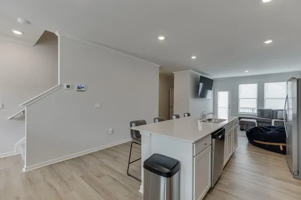 a kitchen with a sink appliances and cabinets
