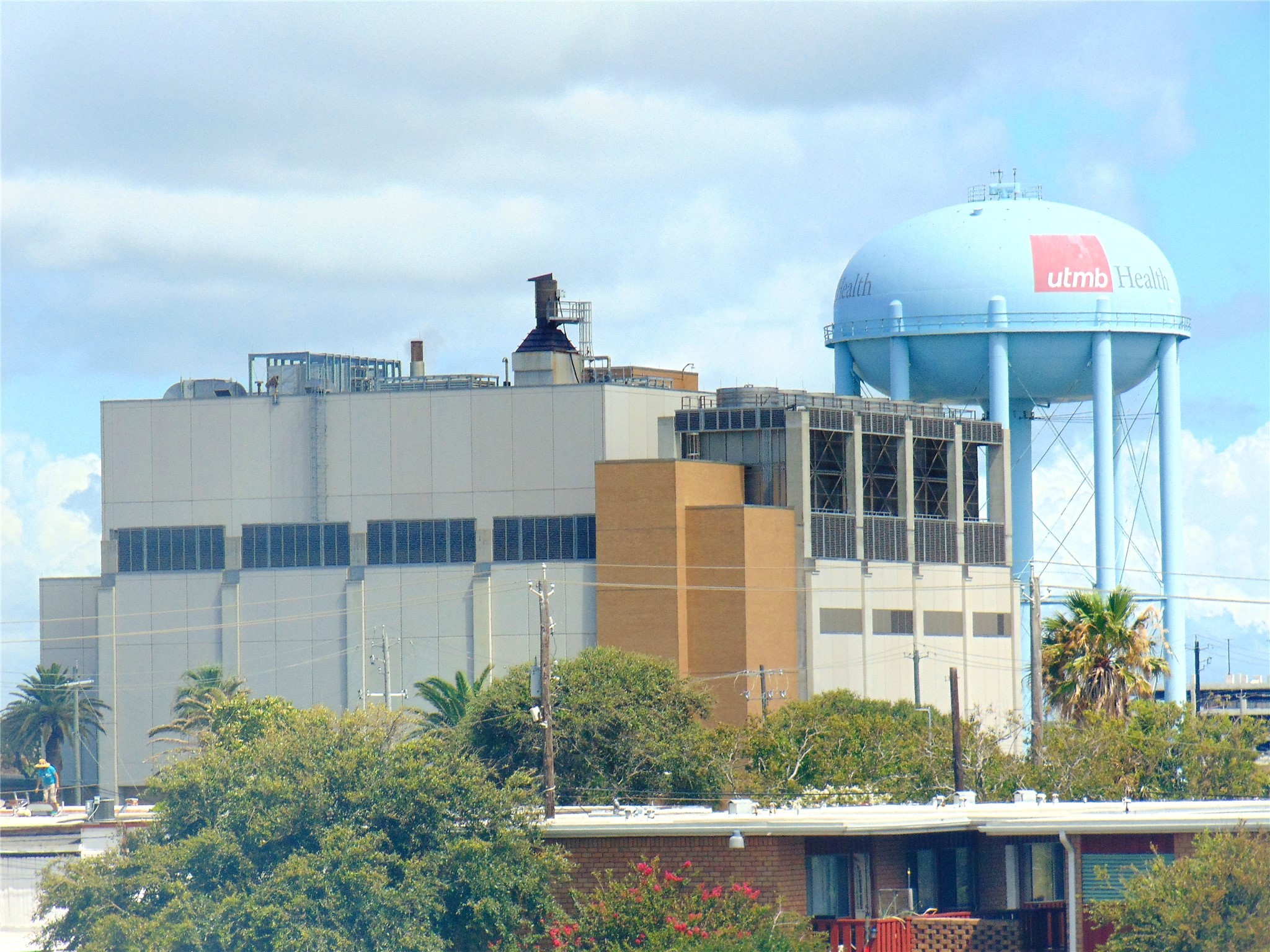 215 Postoffice Street, Unit 1005 Galveston, TX 77550 - Photo 14 of 16 a front view of a house with a yard and sitting space