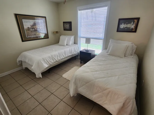 a bedroom with bed and a night stand