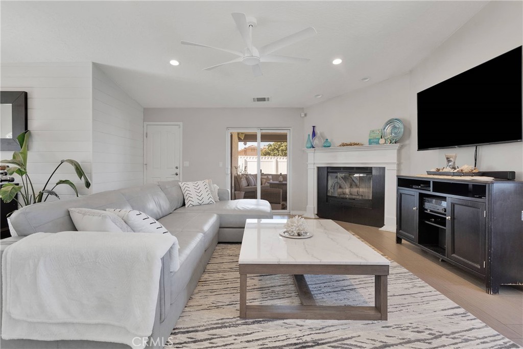 8621 Aster Road Oak Hills, CA 92344 - Photo 13 of 54 a living room with furniture and a flat screen tv