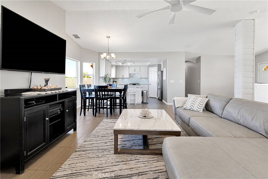 8621 Aster Road Oak Hills, CA 92344 - Photo 14 of 54 a living room with furniture and a flat screen tv