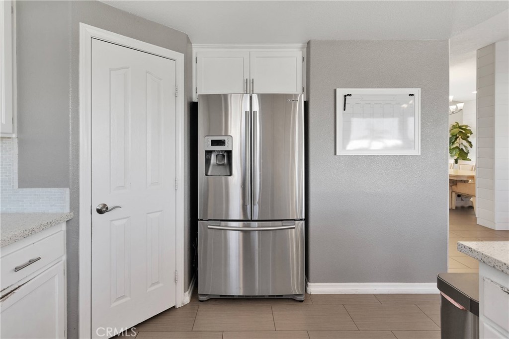 8621 Aster Road Oak Hills, CA 92344 - Photo 18 of 54 a kitchen with stainless steel appliances granite countertop a refrigerator and a sink