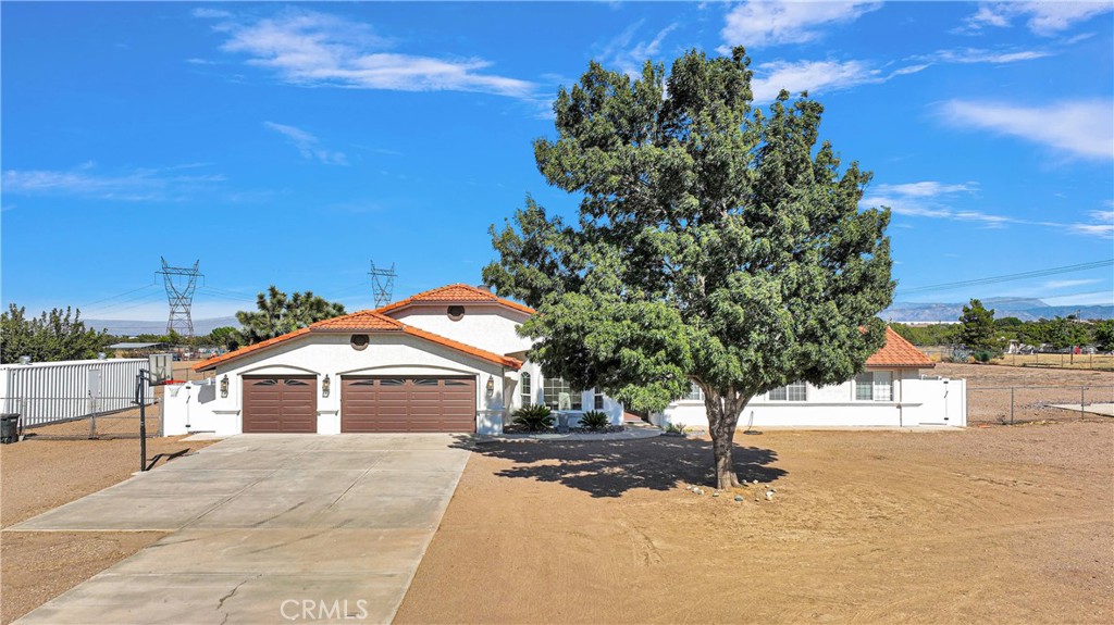 8621 Aster Road Oak Hills, CA 92344 - Photo 2 of 54 a view of a house with a yard
