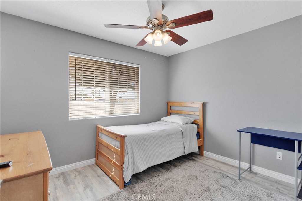 8621 Aster Road Oak Hills, CA 92344 - Photo 21 of 54 a bed room with a bed and a window