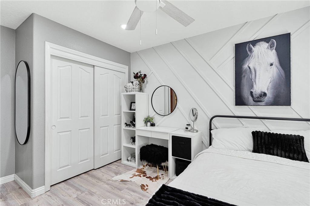 8621 Aster Road Oak Hills, CA 92344 - Photo 25 of 54 a room with a bed and a painting on the wall