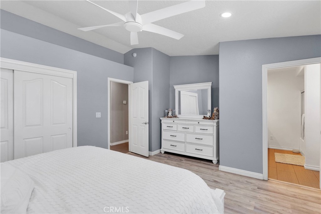 8621 Aster Road Oak Hills, CA 92344 - Photo 28 of 54 a bedroom with a bed and a dresser