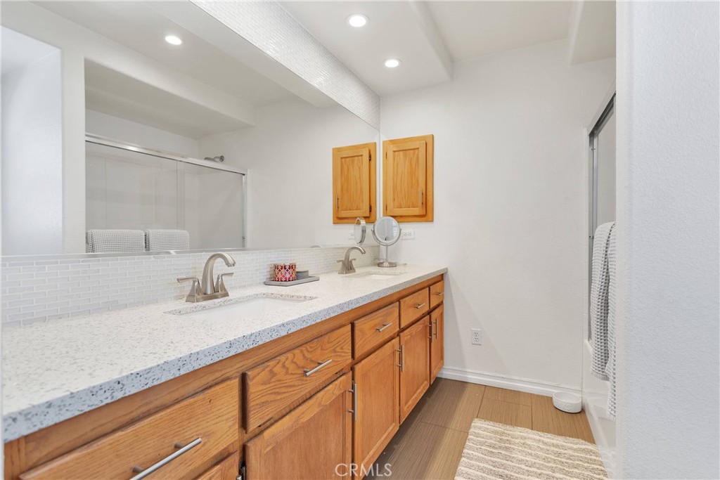 8621 Aster Road Oak Hills, CA 92344 - Photo 30 of 54 a bathroom with a sink and a mirror