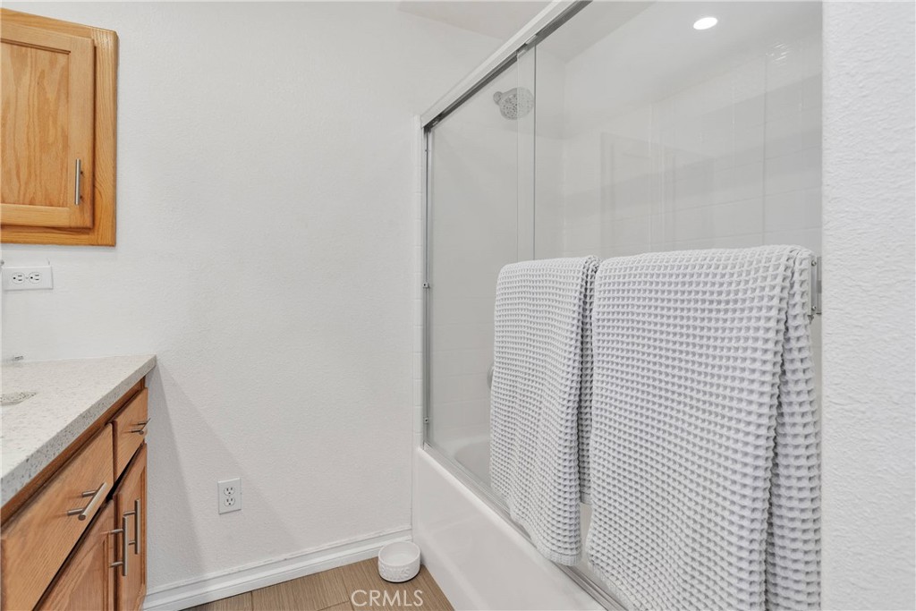 8621 Aster Road Oak Hills, CA 92344 - Photo 31 of 54 a bathroom with a shower and a sink