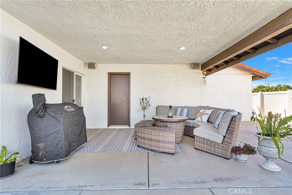 8621 Aster Road Oak Hills, CA 92344 - Photo 34 of 54 a living room with furniture and a flat screen tv