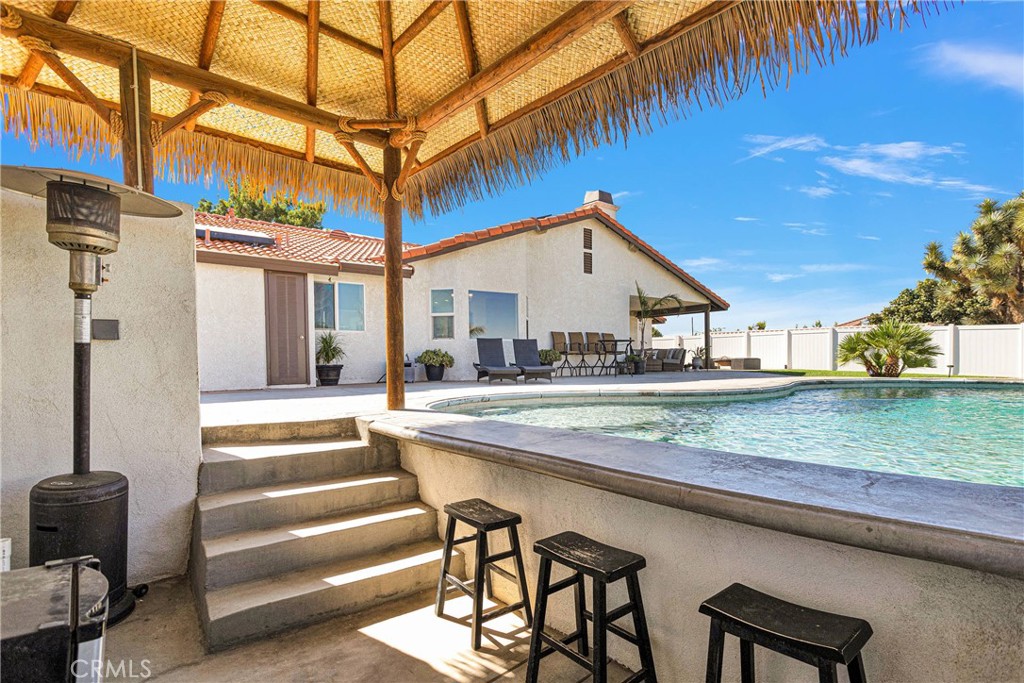 8621 Aster Road Oak Hills, CA 92344 - Photo 41 of 54 a view of a house with a swimming pool