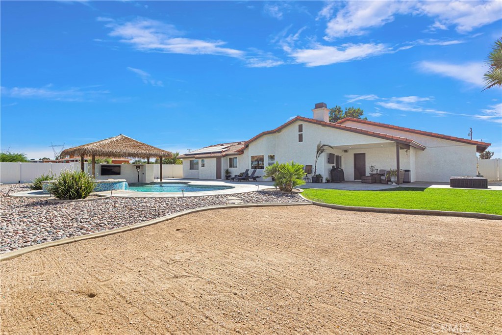 8621 Aster Road Oak Hills, CA 92344 - Photo 43 of 54 a house with garden in front of it