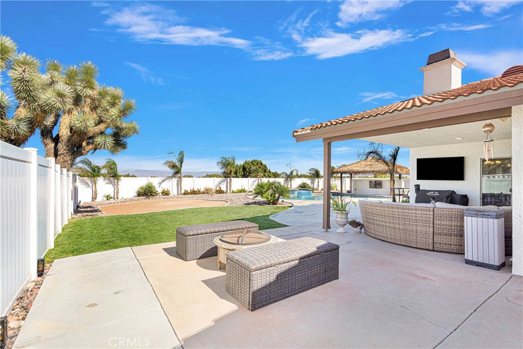 8621 Aster Road Oak Hills, CA 92344 - Photo 44 of 54 a view of a patio with couches and potted plants