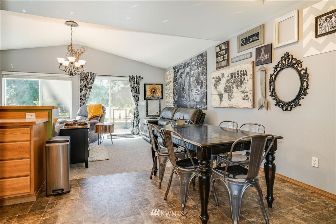 7610 187th Avenue Southwest Rochester, WA 98579 - Photo 11 of 39 a view of a dining room with furniture and chandelier