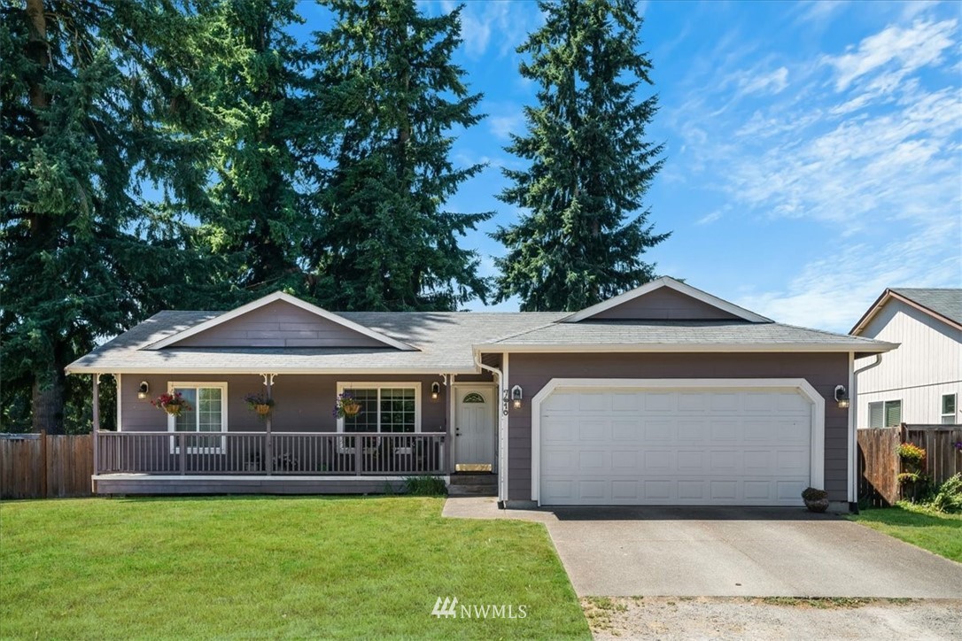 7610 187th Avenue Southwest Rochester, WA 98579 - Photo 3 of 39 a front view of a house with a garden