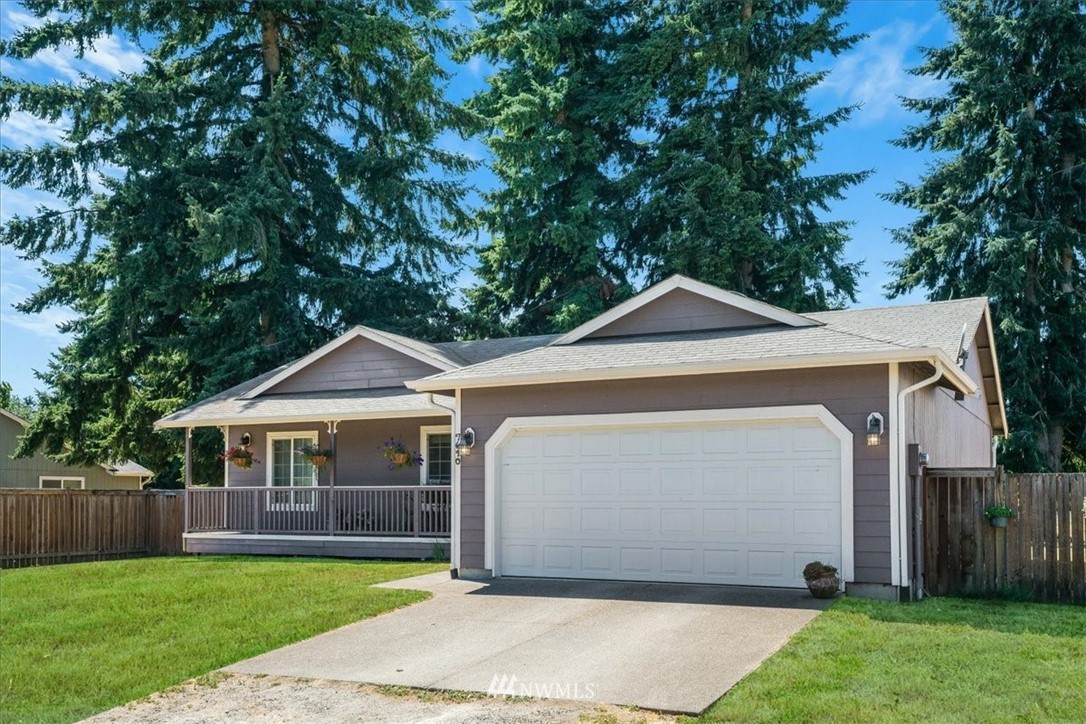 7610 187th Avenue Southwest Rochester, WA 98579 - Photo 4 of 39 a front view of a house with a yard and garage