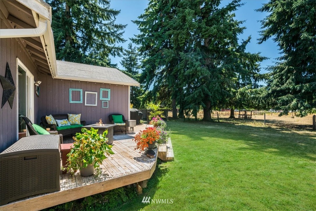 7610 187th Avenue Southwest Rochester, WA 98579 - Photo 33 of 39 a backyard of a house with lots of green space