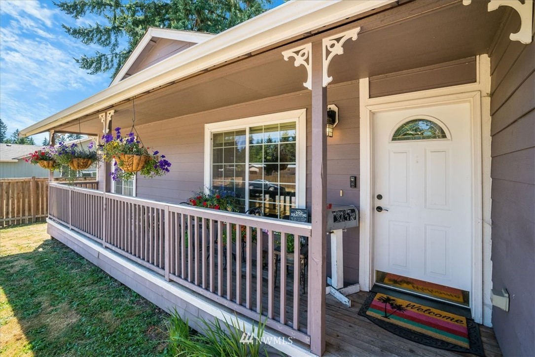7610 187th Avenue Southwest Rochester, WA 98579 - Photo 5 of 39 a view of a balcony with chair and wooden floor