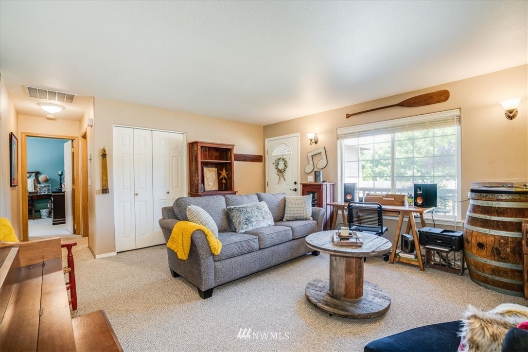 7610 187th Avenue Southwest Rochester, WA 98579 - Photo 10 of 39 a living room with furniture and a large window