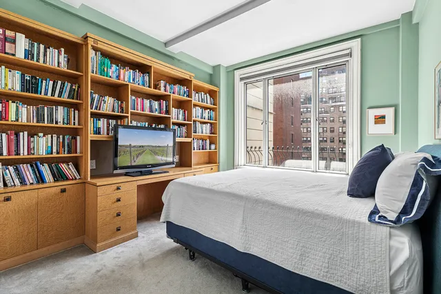 a bed sitting in front of a window