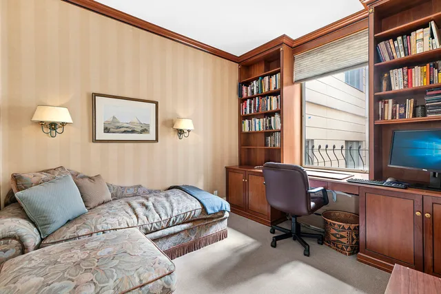 a bed room with a bed and a chair