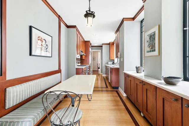 a large kitchen with stainless steel appliances granite countertop a lot of counter space and a wooden floors