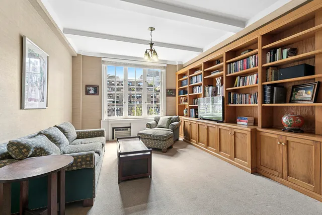 a view of a hallway with furniture and windows