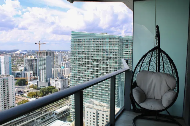 a living room with furniture and a air conditioner vent