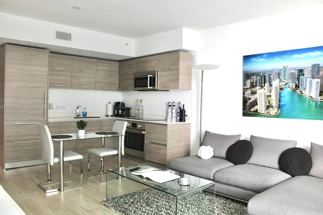 a bedroom with a bed a mirror and a large window