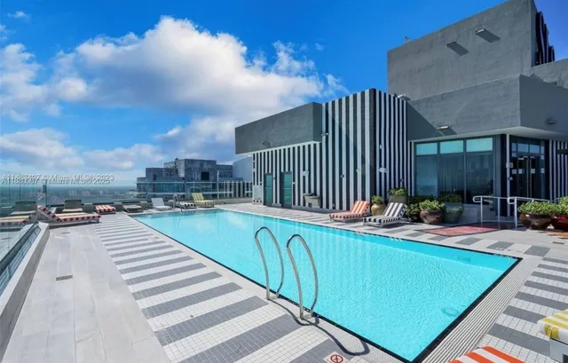 a swimming pool with outdoor seating and yard