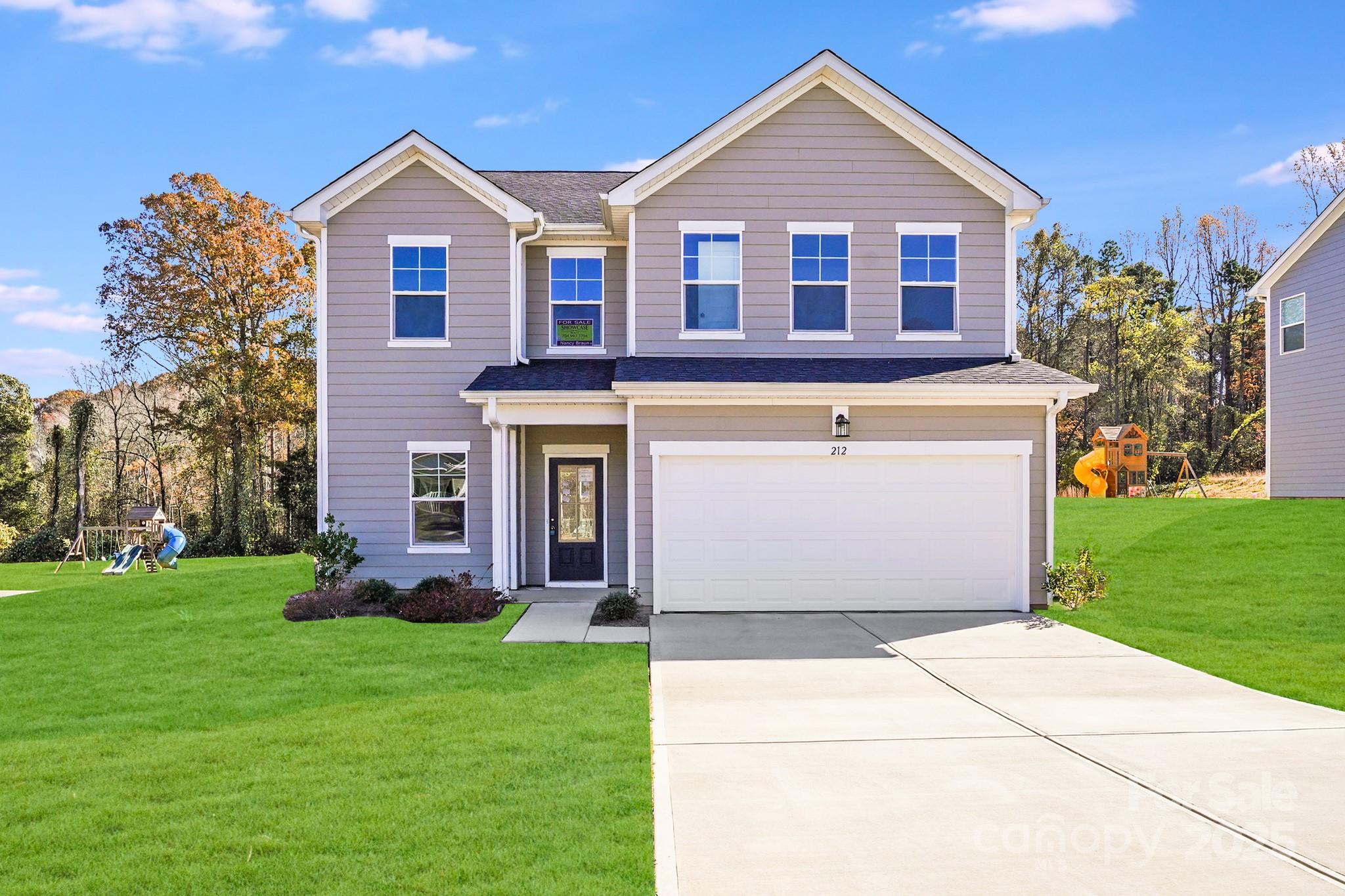 a front view of house with yard and green space