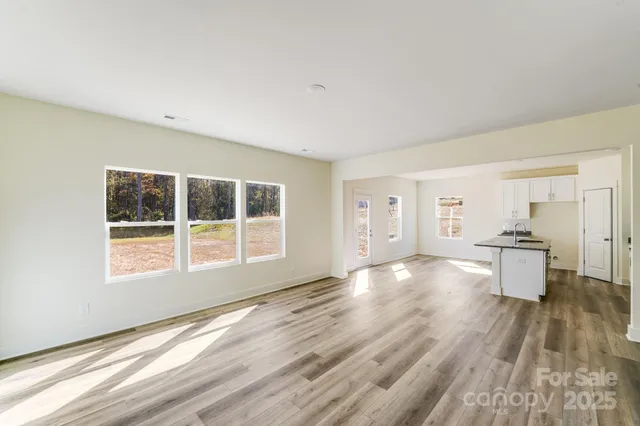 a view of a room with wooden floor and a window