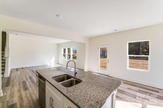 a kitchen with a sink a stove and cabinets