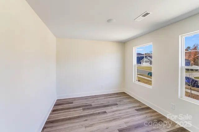 a view of room with window and wooden floor