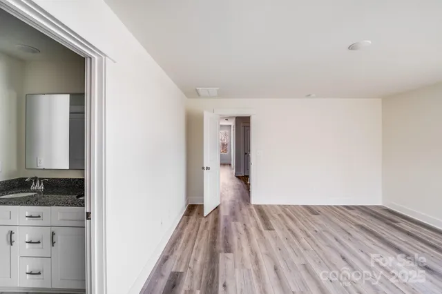 a view of hallway with wooden floor