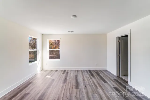 a view of a room with wooden floor and window