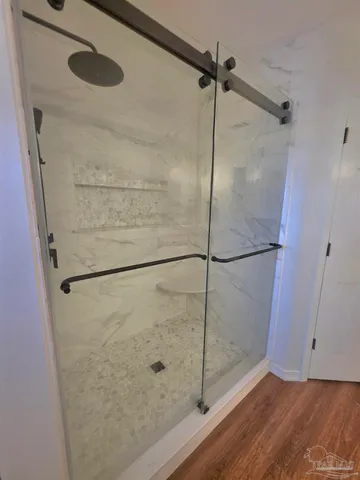 a bathroom with a glass shower door