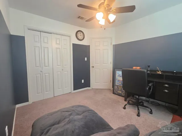 a bedroom with a workspace