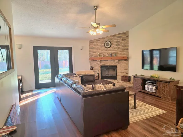 a living room with furniture a fireplace and a flat screen tv