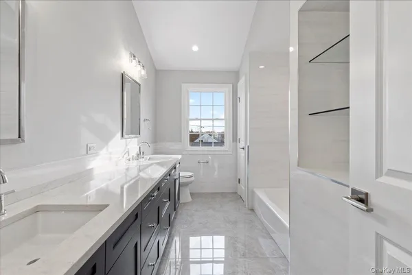 a bathroom with a sink double vanity and a mirror